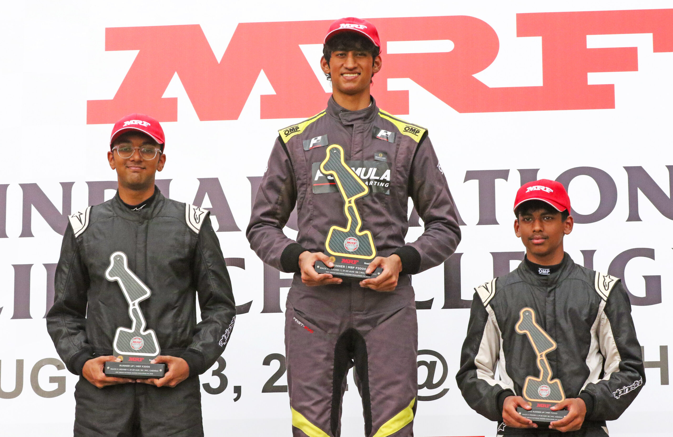 MRF F2000 race winner Saishiva Sankaran (centre) flanked by Aditya Patnaik (left, second) and Swarnav Das (third)